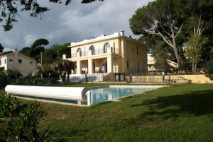 a large house with a pool in front of it at Caravelle 60 in Antibes +14 photos