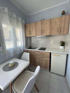 a kitchen with a table and chairs and a white counter top at The Little Prince in Petra +9 photos