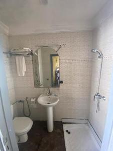 a bathroom with a sink and a toilet and a mirror at HOTEL AL MAMOUN in Casablanca +24 photos