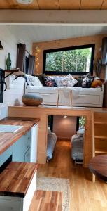 a living room with a large window in a tiny house at My Tiny House proche mer in Clohars-Fouesnant