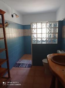 a bathroom with a toilet and a sink at Finca Rústica La Pájara in Iznatoraf +34 photos