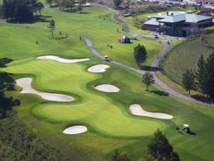 an overhead view of a golf course with a bunch of golf greens at Playa de Miño in Miño