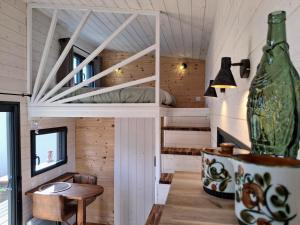 a room with a bed and a table and a vase at My Tiny House proche mer in Clohars-Fouesnant