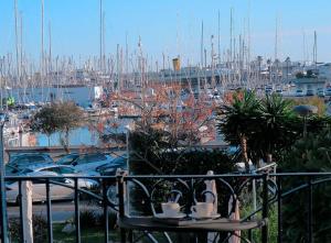 a balcony with a view of a marina with boats at Entire Flat First Beach line - Sea Views - Vilanova i Geltru in Vilanova i la Geltrú