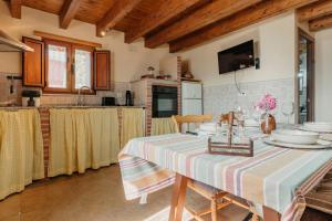 a kitchen with a table with a striped table cloth at La Casina de Maxa in Suares