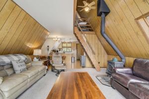 a living room with a couch and a fireplace at Slope Summit Rustic A-Frame Cabin w Scenic Views in Divide +29 photos