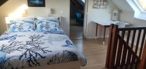 a bedroom with a bed with blue and white sheets at Château de Montmireil in Canisy +16 photos