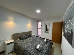 a bedroom with a bed with two towels on it at Urban, Quiet flat for Digital & Remote Nomads in Santa Cruz de Tenerife