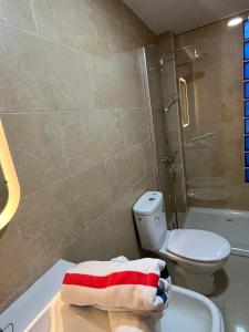 a bathroom with a toilet and a sink and a shower at Urban, Quiet flat for Digital & Remote Nomads in Santa Cruz de Tenerife +19 photos