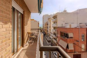 an apartment balcony with a view of a street at El Retiro de Julián in Santa Pola