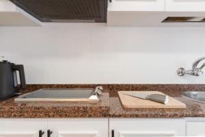 a kitchen counter with a sink and a cutting board at El Retiro de Julián in Santa Pola +66 photos