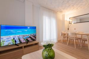 a living room with a large flat screen tv at El Retiro de Julián in Santa Pola