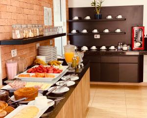 a breakfast buffet in a hotel room with food at Barra Hotel in Vargem Grande do Sul +8 photos