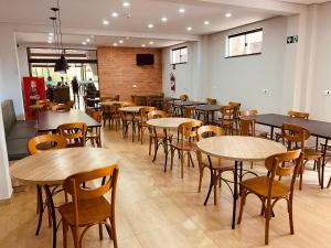 a restaurant with tables and chairs in a room at Barra Hotel in Vargem Grande do Sul