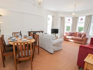 a living room with a table and a couch at Seawinds in Colwyn Bay