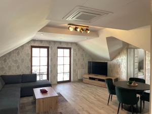 a living room with a couch and a table at Penzión Grobský Dvor in Slovenský Grob