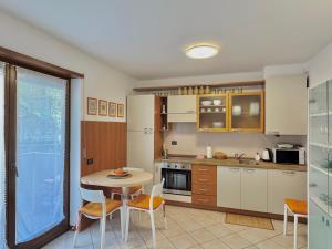 a kitchen with a table and chairs in a room at 1Dest - Casa Bont in Riva del Garda +5 photos