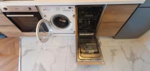 a washer and dryer sitting in a kitchen at Architect's studio with pool, sea view and AC in Théoule-sur-Mer