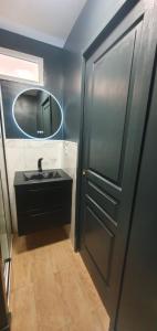 a bathroom with a black sink and a mirror at Architect's studio with pool, sea view and AC in Théoule-sur-Mer +7 photos