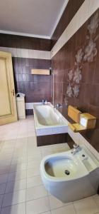 a bathroom with a tub and a sink at Villa Brazil B&B in Lido di Jesolo +63 photos