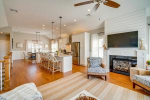 a large living room with a fireplace and a kitchen at Close to Brigantine Beach Home with 2 Decks in Brigantine
