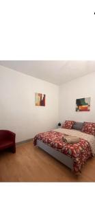 a bedroom with a bed with a red blanket at Appartement studio au cœur de Strasbourg in Strasbourg