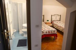 a bathroom with a bed and a toilet and a sink at Appartamenti Le Giare Cannicchio in Cannicchio