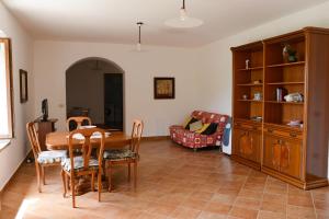 a living room with a table and a couch at Appartamenti Le Giare Cannicchio in Cannicchio +12 photos