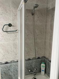 a shower with a glass door next to a sink at Apartamento La Pineda a 100 metros de la playa!! in La Pineda