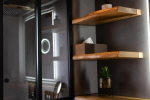 a room with a shelf with a plant on it at Boutique Apartments by Roy Oberhausen in Oberhausen +138 photos