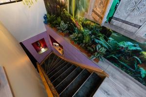 an overhead view of a spiral staircase with plants at Boutique Apartments by Roy Oberhausen in Oberhausen