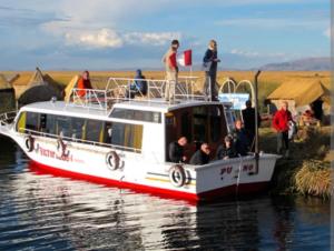 a boat with people on it on the water at Vista Alegre in Puno