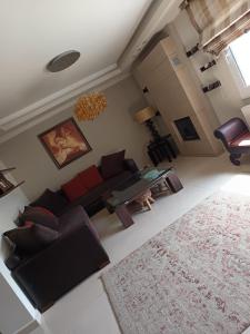 a living room with a couch and a table at beach house Blue Sea in Iraklitsa