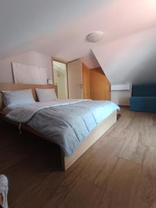 a bedroom with a large bed with a blue blanket at beach house Blue Sea in Iraklitsa