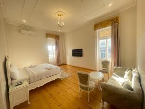 a bedroom with a bed and a couch and a table at Atum in Cairo