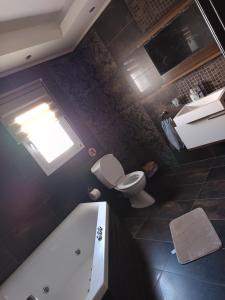 an overhead view of a bathroom with a toilet and a tub at beach house Blue Sea in Iraklitsa +28 photos