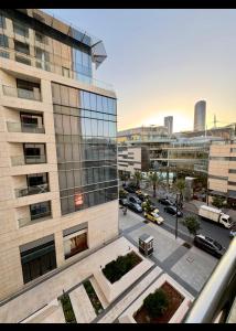 an aerial view of a city with a building at Amman studio Damac Tower in Amman