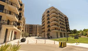 an empty street in front of two apartment buildings at Montenegro Luxury Studio - Hill Homes in Podgorica