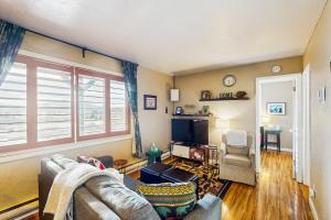 a living room with a couch and a tv at Winter Park Meadows Lodge in Fraser