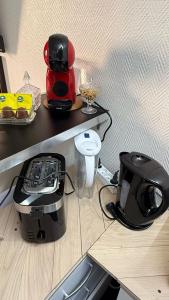 a kitchen counter with a coffee maker and a blender at Comfortable Studio à proximité de porte Versaille , Paris in Vanves