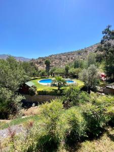 a resort with two swimming pools in a field at Bellísima casa en La Aurora in Curacaví