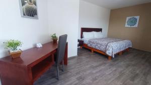 a room with a desk and a bed and a desk sidx sidx sidx at Noas Hotel in Matamoros