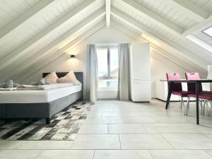 una camera da letto con un letto, un tavolo e delle sedie di Loft apartment in a central location a Winterthur