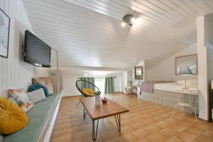a bedroom with a bed and a table in a room at Athina Guesthouse in Hydra
