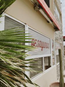 a window of a building with a sign on it at Noas Hotel in Matamoros
