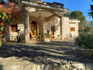 an entrance to a stone house with a patio at Trulli Pinnacoli in Locorotondo