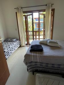 Postel nebo postele na pokoji v ubytování Hospedagem Chris Art Music