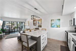 a kitchen with a island in the middle of a room at Anglers Cove Unit J205 in Marco Island