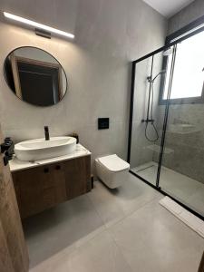 a bathroom with a toilet and a sink and a shower at 201 Lux Suite Tower206 in Lakatamia