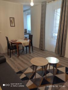 a living room with a dining room table and chairs at Du Guesclin Appart in Saint-Brieuc